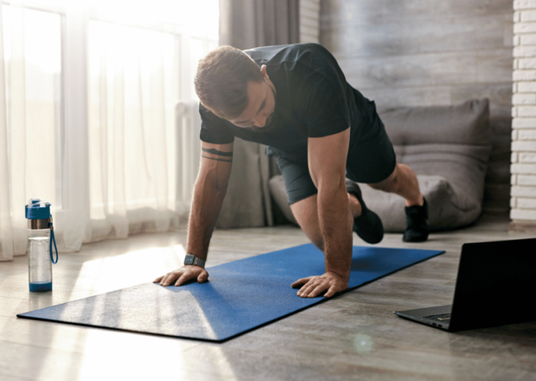 Male exercising on a yoga mat