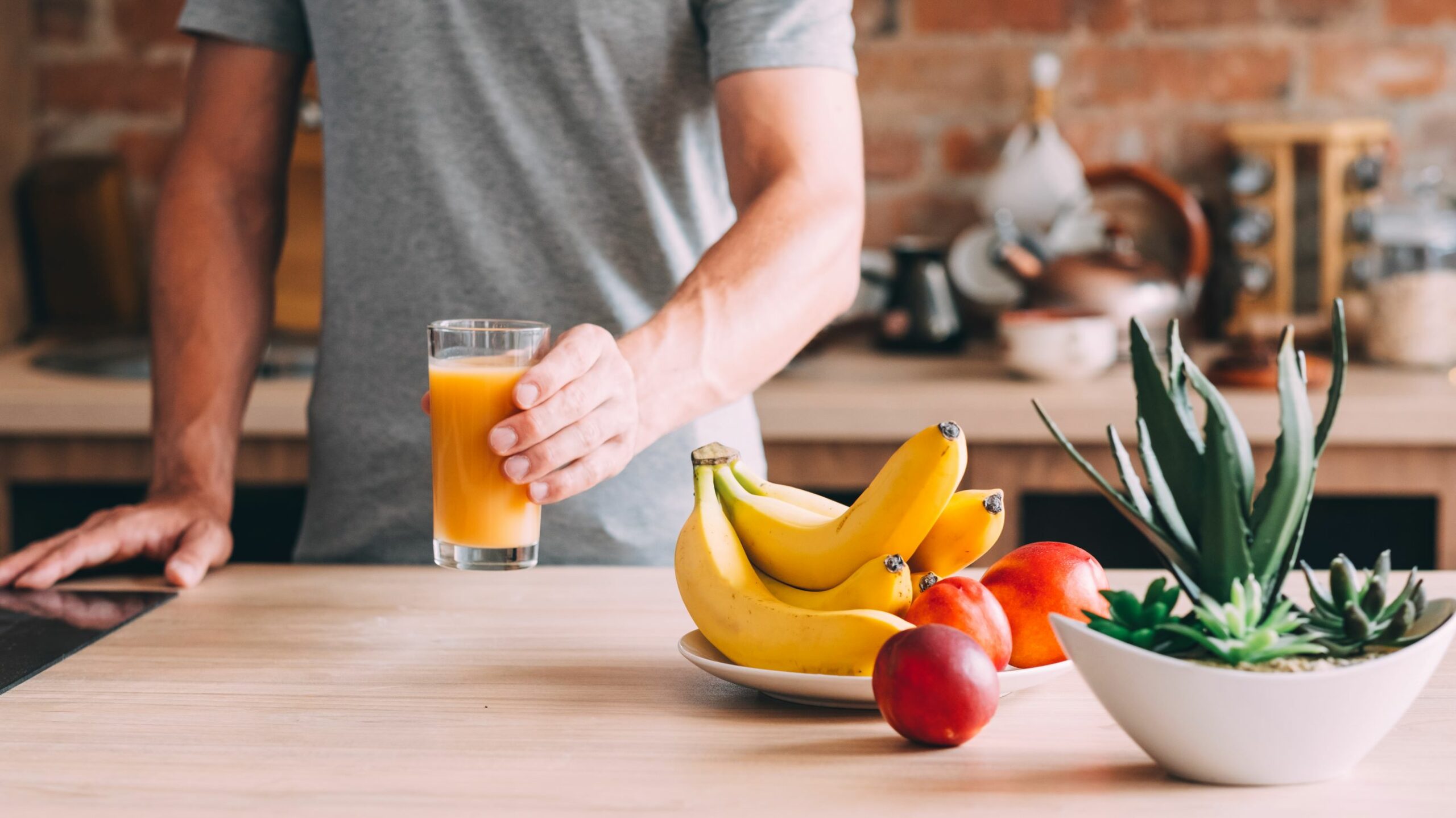 healthy fruit and smoothie placed on a kitchen counter