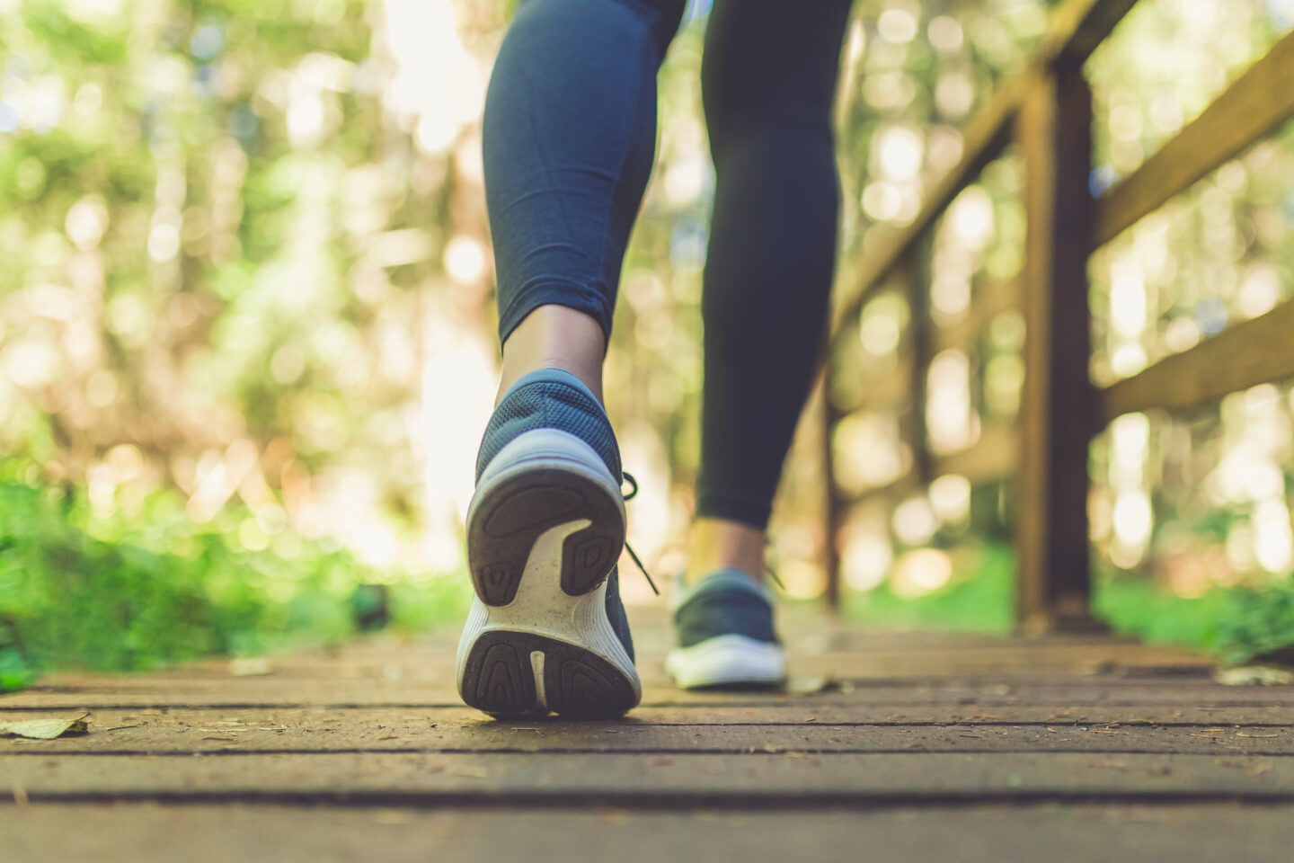 Woman runner feet walking in nature.