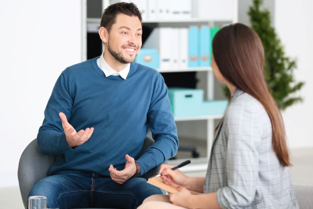 man speaking to counsellor - employee assistance programme