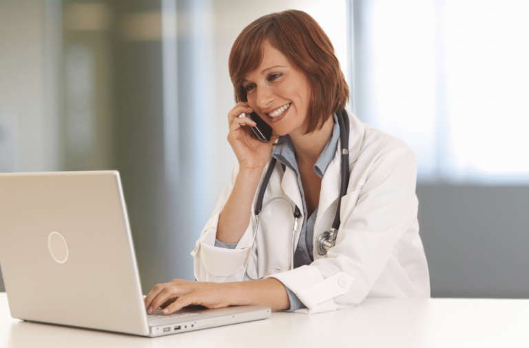 Female Doctor on the phone smiling