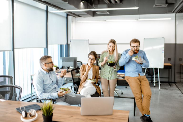 Employees eating healthy food in an office