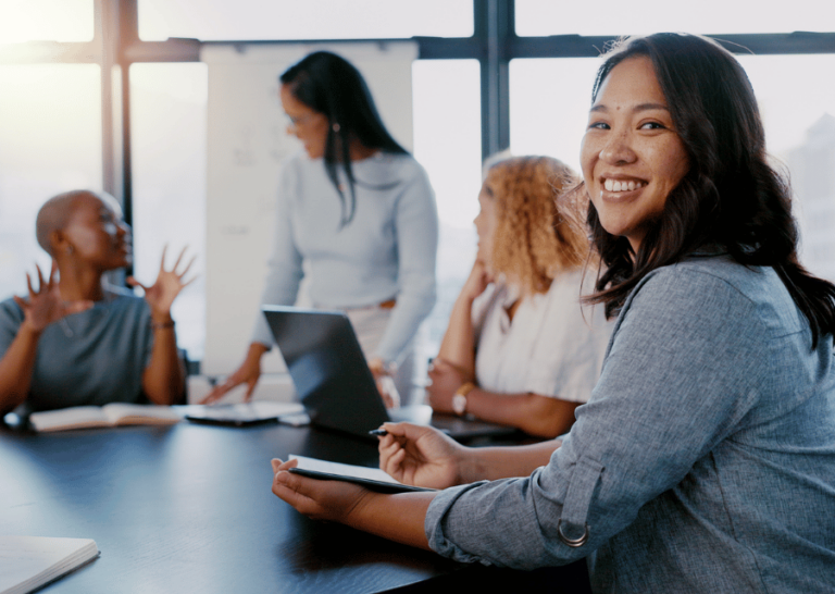 A diverse group of four happy female colleagues meeting