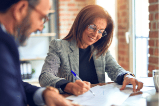 male and female employee business meeting studying documents