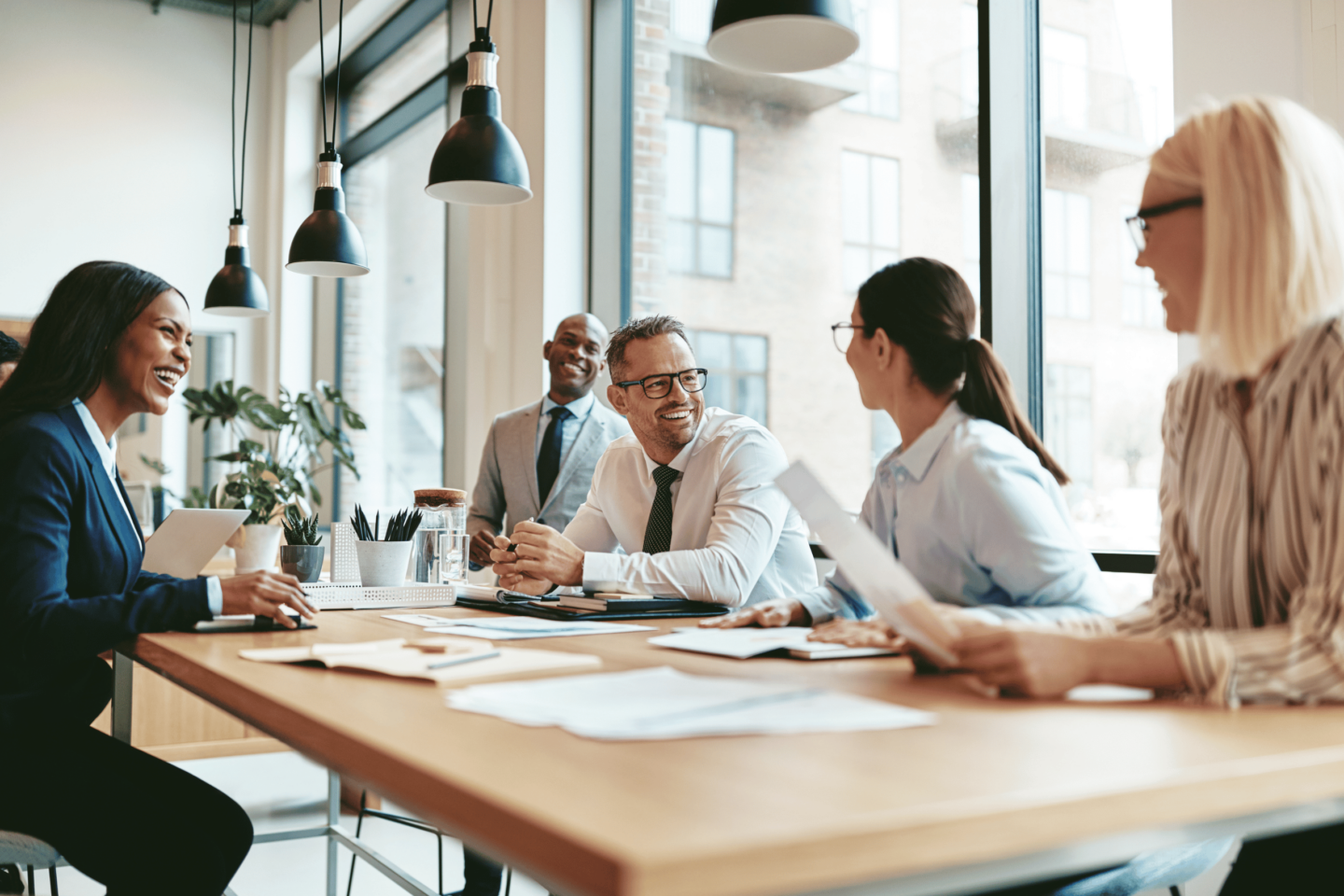 Diverse group of employees smiling during a business meeting