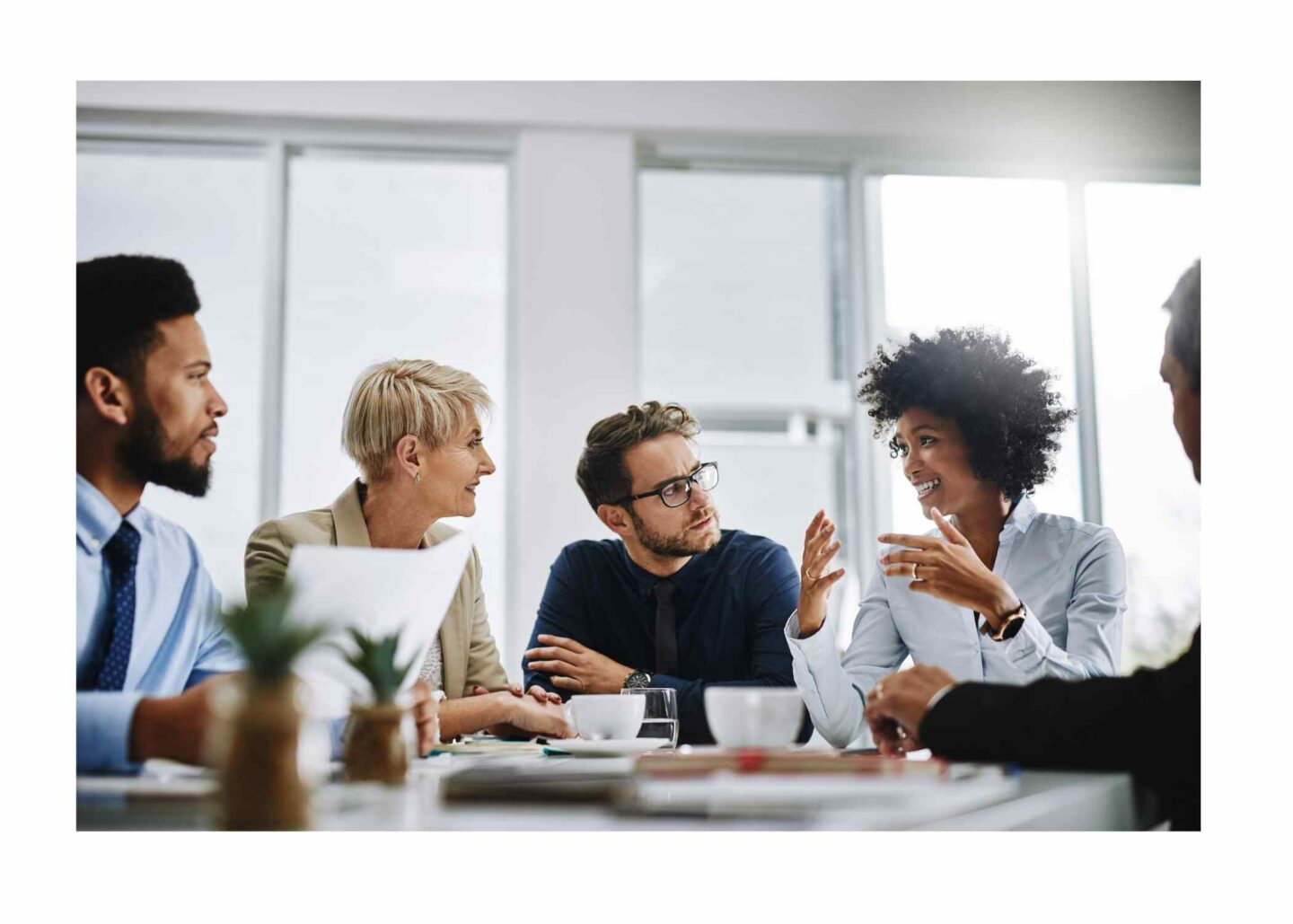 A diverse group of five colleagues gathered for a working lunch break.