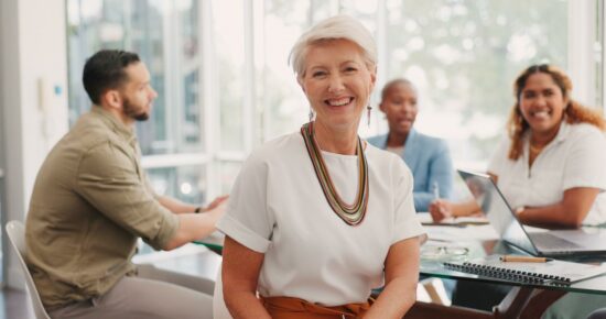 October menopause mProve in 30 webinar graphic short haired female smiling with 2 other females and 1 male sat around a table behind her