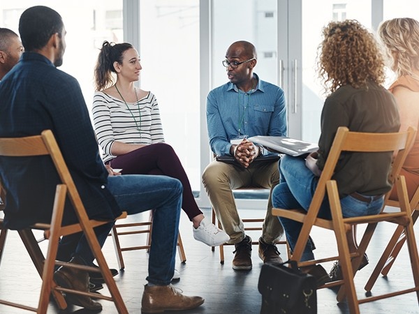 Group of people gathered round on chairs in a circle