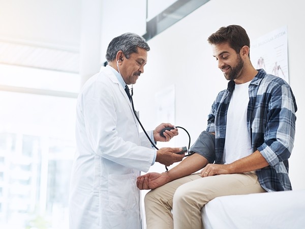Doctor doing a check up on a male patient