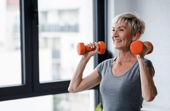 Fit for change menopause course image shows short haired lady lifting weights