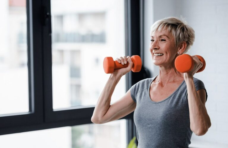 Fit for change menopause course image shows short haired lady lifting weights