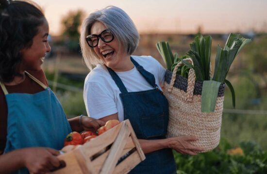 Image shows older women carrying fresh produce